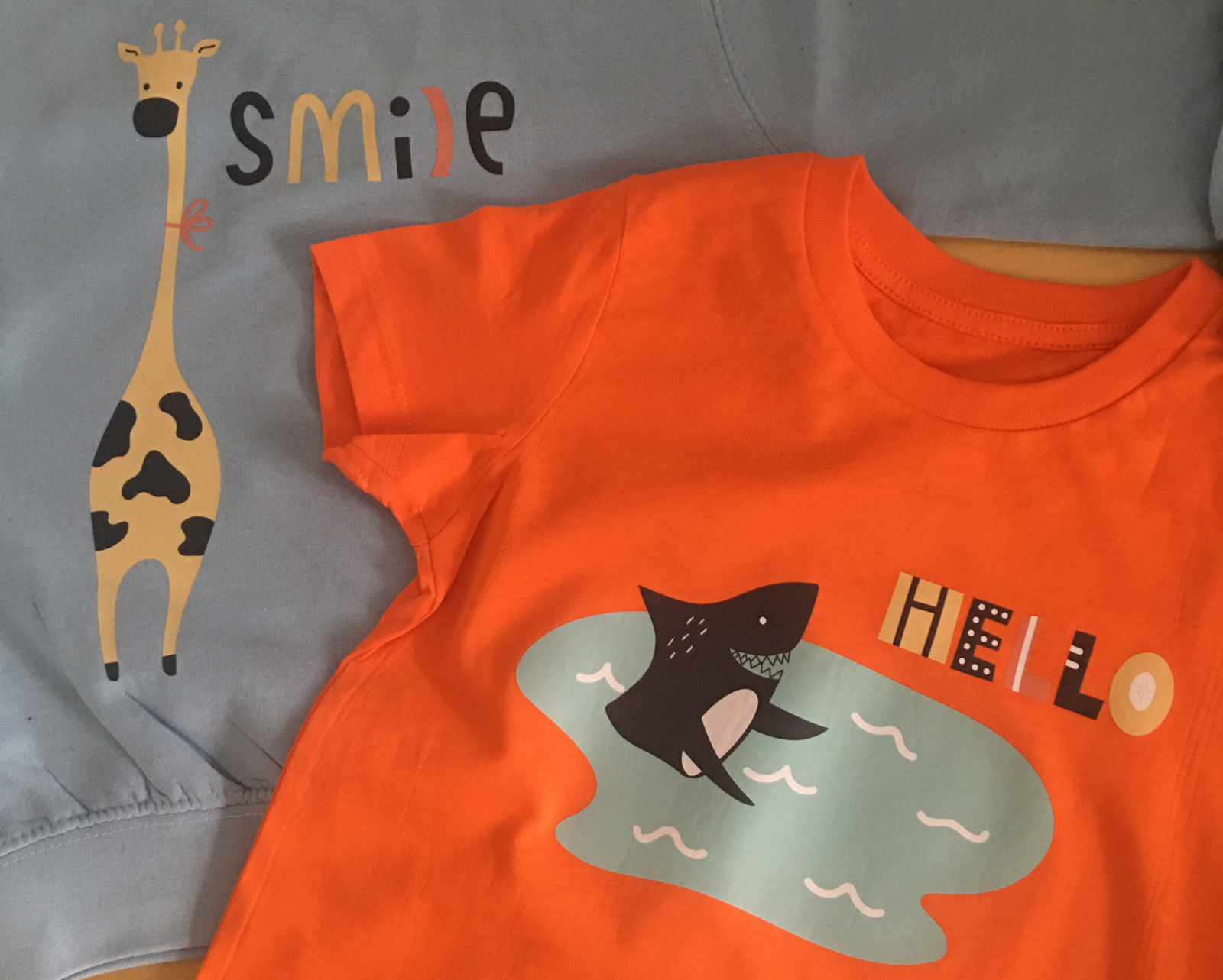Children's garments with giraffe and shark